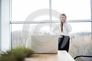 Woman speak phone in office and smile of good news