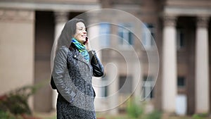 Woman speak phone and smile happily in the autumn park