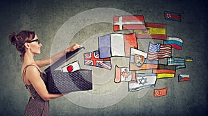 Woman speaks different languages opening a box with international flags flying away