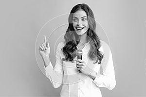 Woman speech, business woman holding a microphone. Young woman talking in microphone, perfom with mic, giving speech