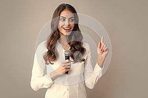 Woman speech, business woman holding a microphone. Young woman talking in microphone, perfom with mic, giving speech