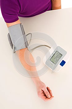 Woman with sphygmomanometer