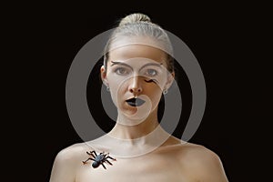 Woman with spider on collarbone close-up