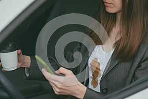 Woman spilled hot coffee on herself while texting while driving. phone daily life dirty stain