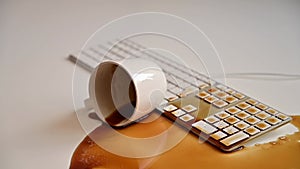 A woman spills a cup of black coffee on the computer keyboard at the desk. Slov motion.