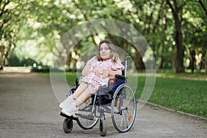 Woman with spinal muscular atrophy smiling at park