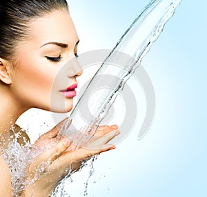 Woman with splashes of water in her hands
