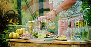 Woman spooning syrup into a cocktail