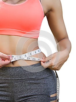 Woman in sport bra measuring her body with tape isolated on white.