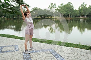 Woman in sport clothes stretch before going for running in the morning