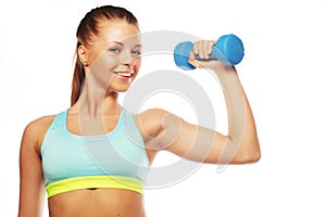 Woman in sport equipment practice with hand weights on white background