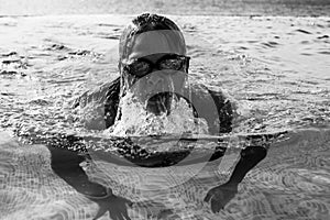 Woman in sport swimwear in a swimming pool, black and white photo