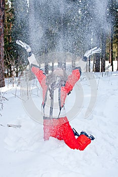 Woman in a sporting suit tosses up snow in-field photo