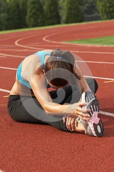 Woman in Sports Bra Leaning and Stretching Leg and Hamstring