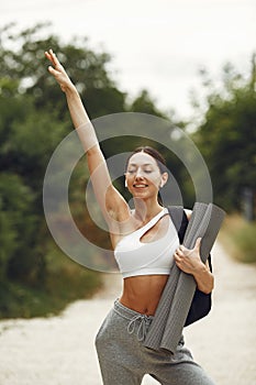 Woman in a sports clothes at the summer park