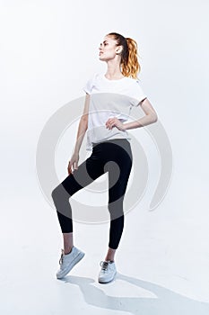 woman in sports uniform workout posing fitness light background