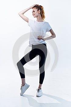 woman in sports uniform workout posing fitness light background