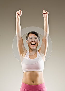 Woman in sportswear cheering and celebrating