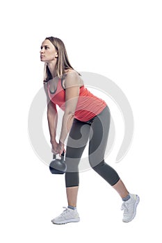 A woman in sportswear does exercises with a weight. Sports, activity and health. Isolated on a white background. Vertical