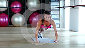 Woman in sportswear does push-ups