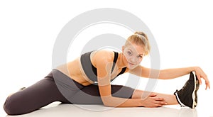 Woman in sportswear doing stretching exercise