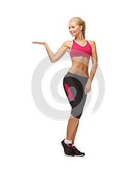 Woman in sportswear with empty hand