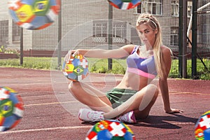 Woman in sportswear with football ball