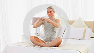 Woman in sportswear on her bed