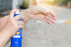 Woman spray at wrist and elbow pain and feeling bad on the road outside between exercise,Health care concept