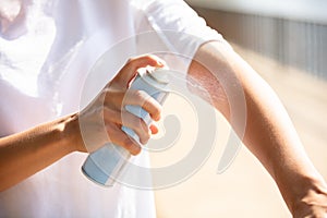 Woman Spraying Anti Insect Deet Spray On Her Hand