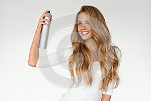 Woman Spraying Hairspray On Beautiful Curly Hair. Hairdressing