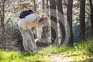 Woman spraying insect repellent against tick at her legs