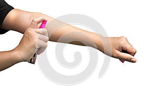 Woman spraying insect repellent on her hand isolated