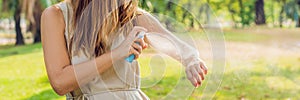 Woman spraying insect repellent on skin outdoor BANNER, long format