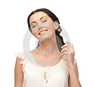 Woman spraying pefrume on her neck