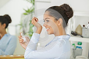 Woman spraying perfume