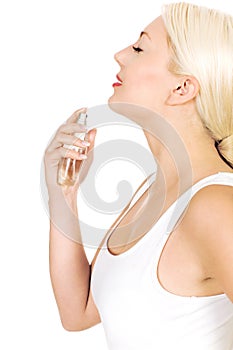 Woman spraying perfume on neck