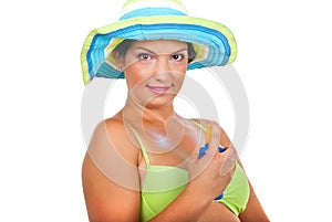 Woman spraying sun protection cream