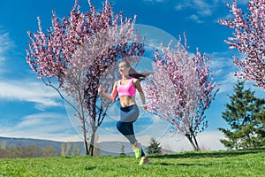 Woman in spring running or jogging as sport