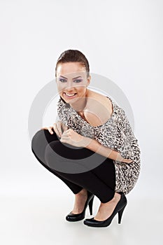 Woman in squat position smiling
