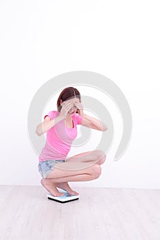 Woman Squatting on weight machine