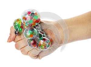 Woman squeezing colorful slime on white, closeup. Antistress toy