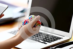 Woman squeezing stress ball at workplace