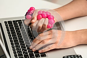 Woman squeezing stress ball at workplace