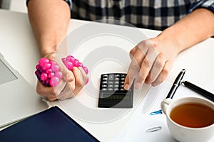 Woman squeezing stress ball at workplace