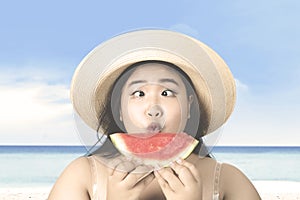 Woman with squint-eyed holds watermelon