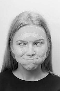 Woman squinting eyes and puffing cheeks on funny face