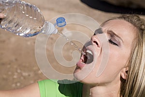 Woman squirting water from bottle