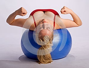 Woman on stability ball makes fists