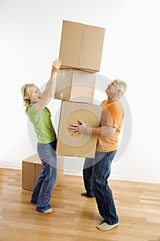 Woman stacking boxes.